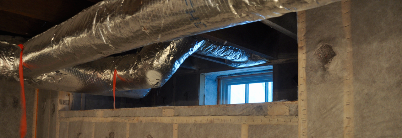 Ducts hanging from the ceiling in a basement