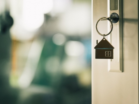 house-shaped housekey opening door