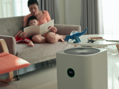 mother and child in background of air filter in foreground