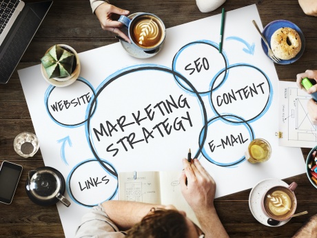 marketing strategy flat lay at coffee shop featuring hands