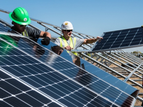 men installing solar panels